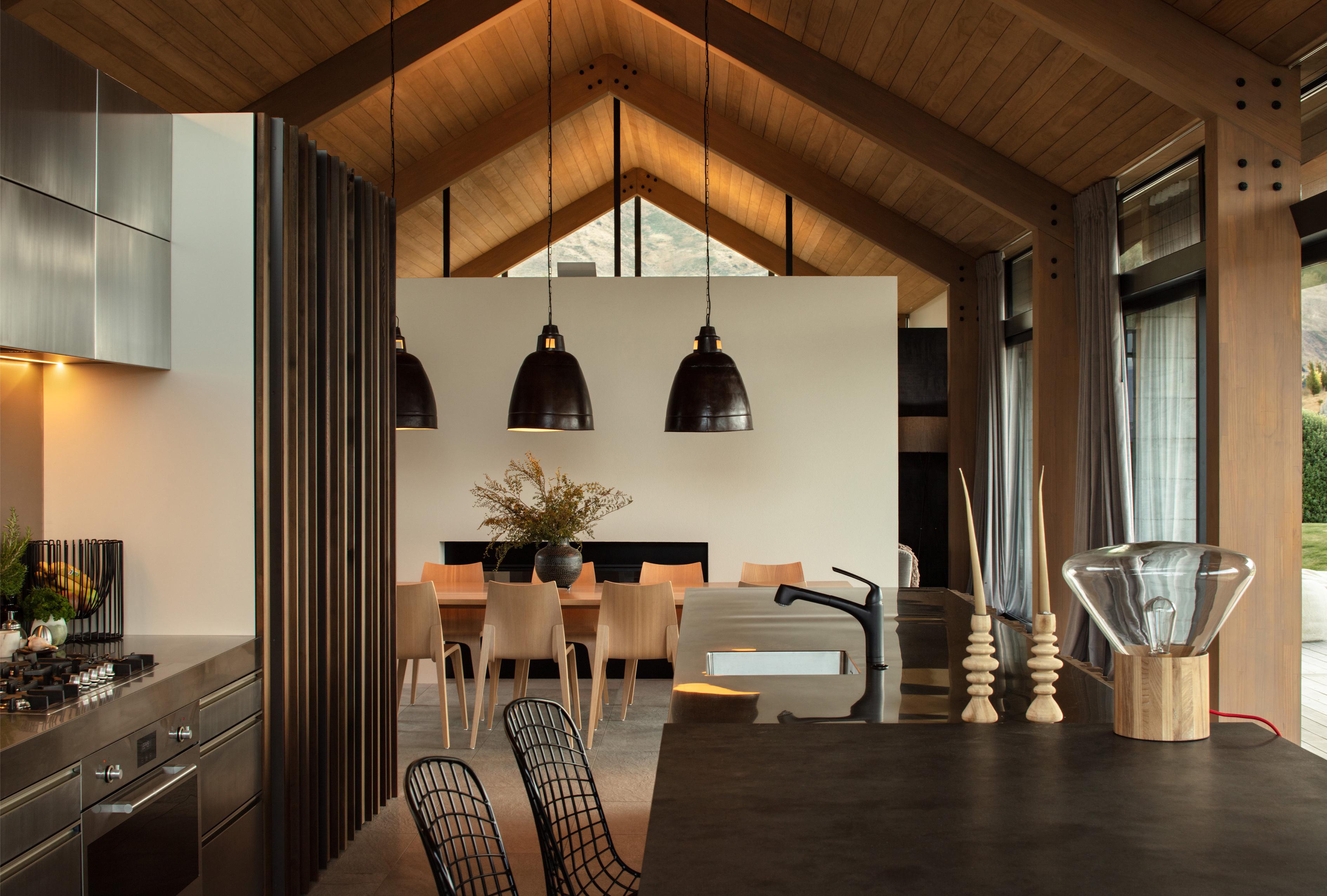 View from the Westmeadows kitchen, looking towards the dining area showcasing pitched roof forms and timber materials