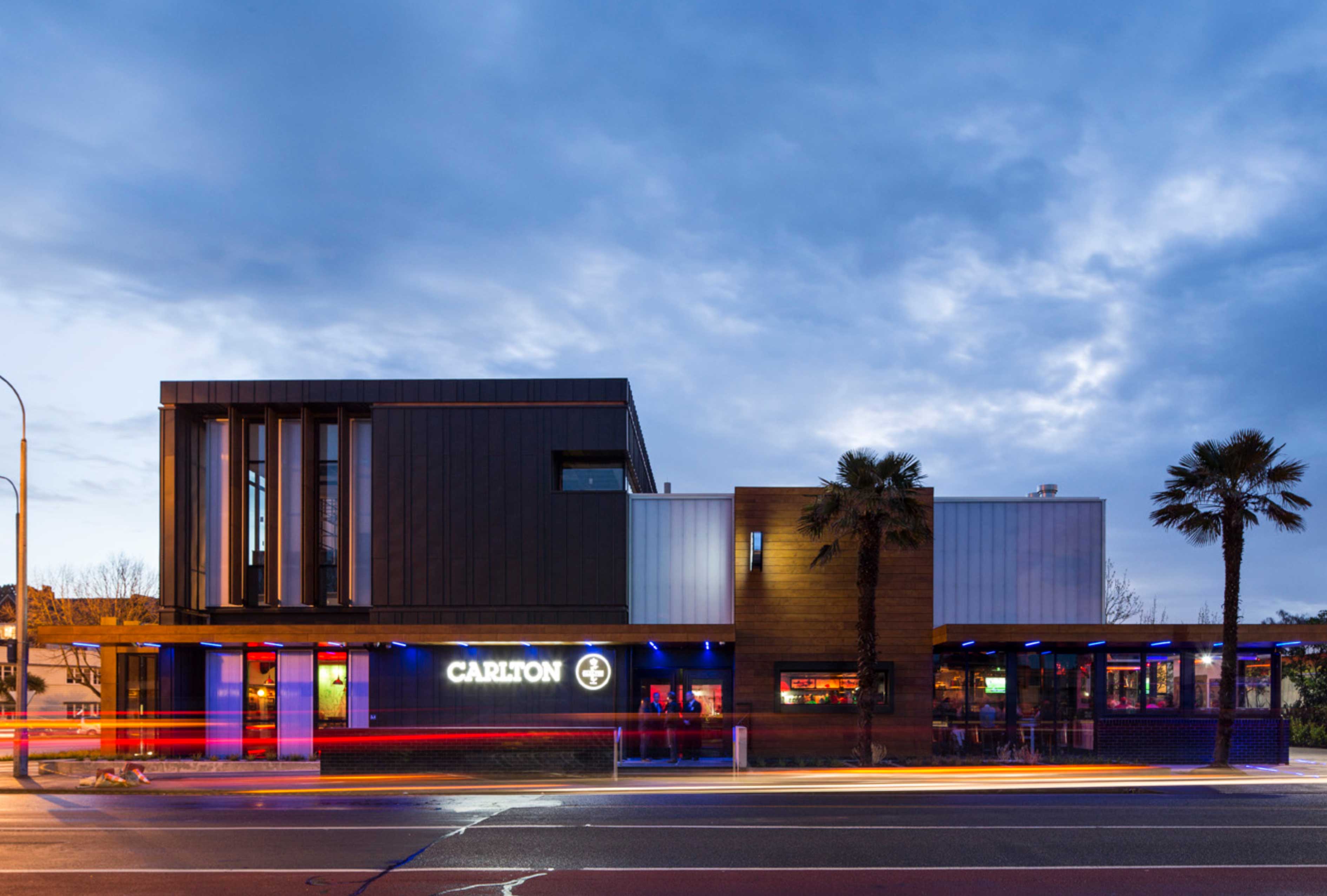 Wide view of Carlton Corner from the side at late-afternoon with prominent Carlton branding