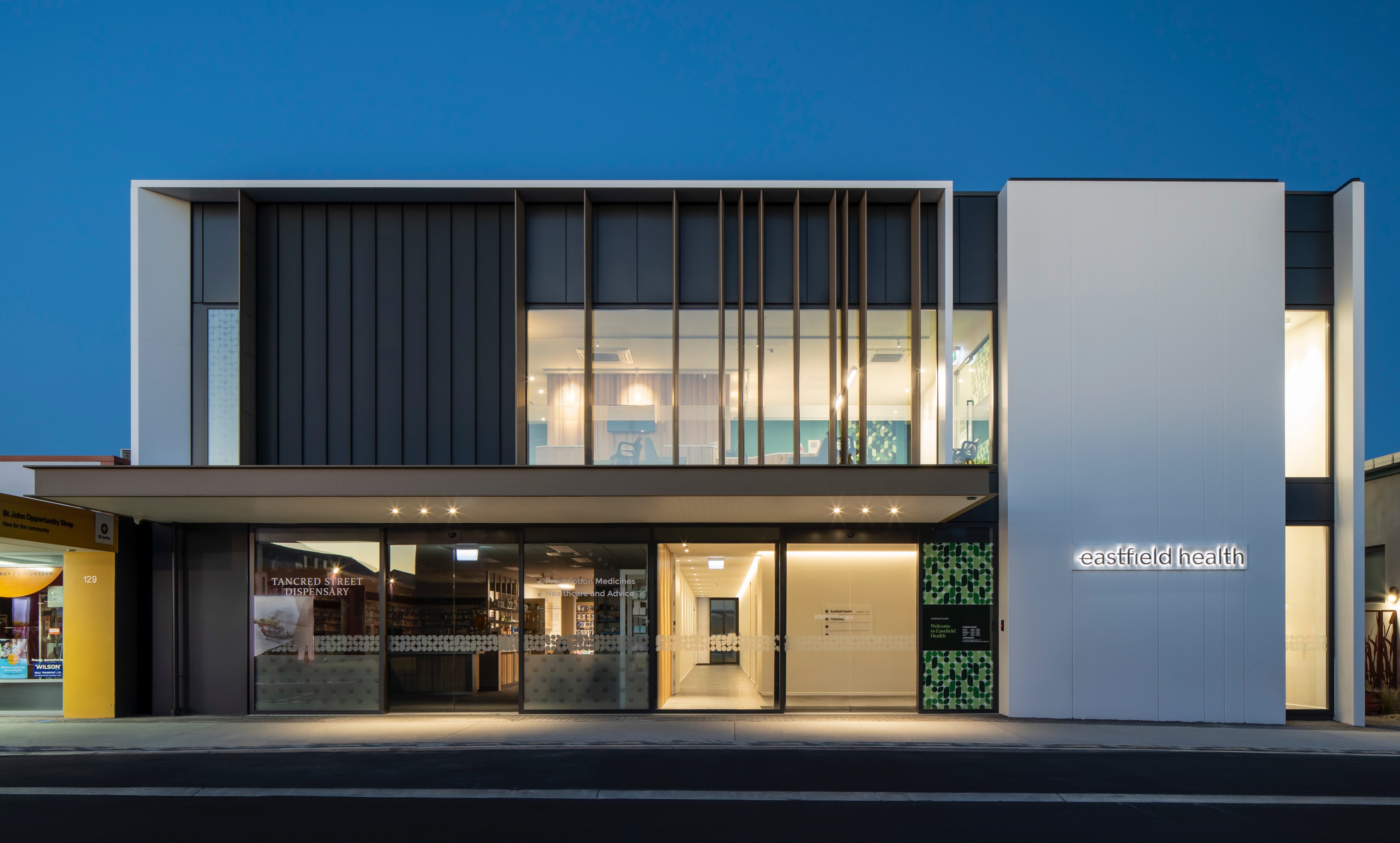 Frontage of Eastfield Health building at night with illuminated windows and signage