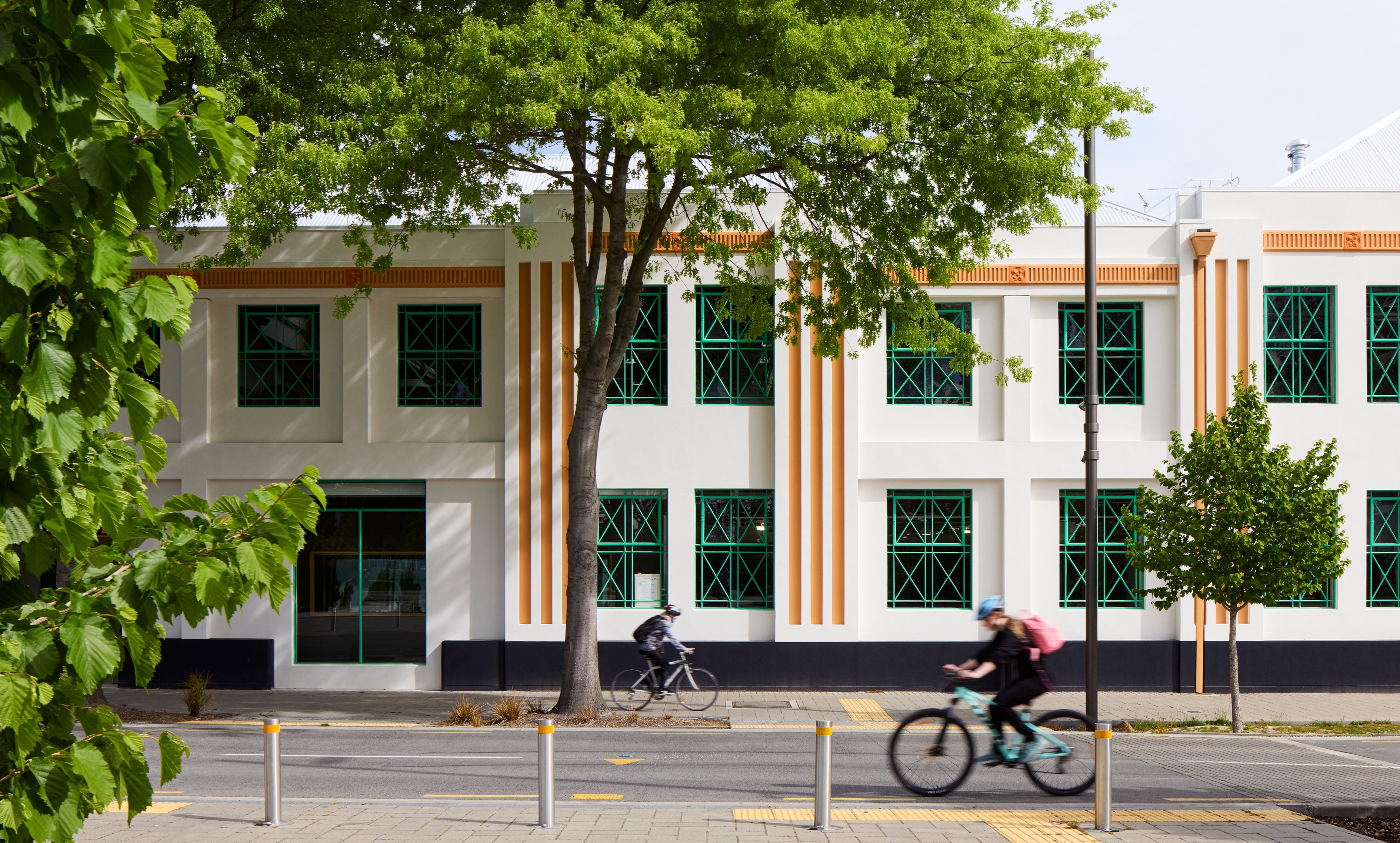 Exterior of house with photovoltaic panels, and children skipping out of open sliding door