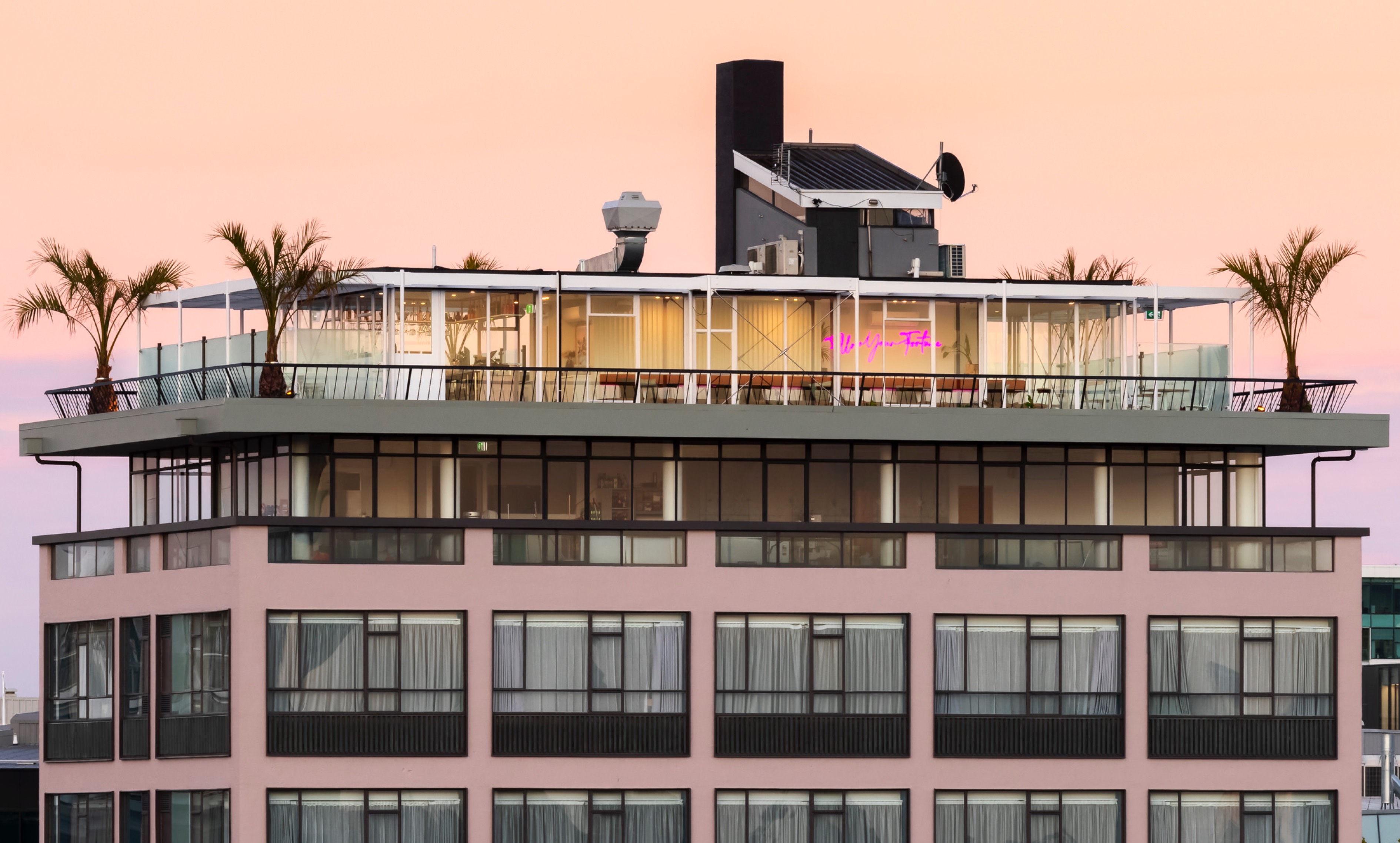 Exterior of rooftop bar at sunset