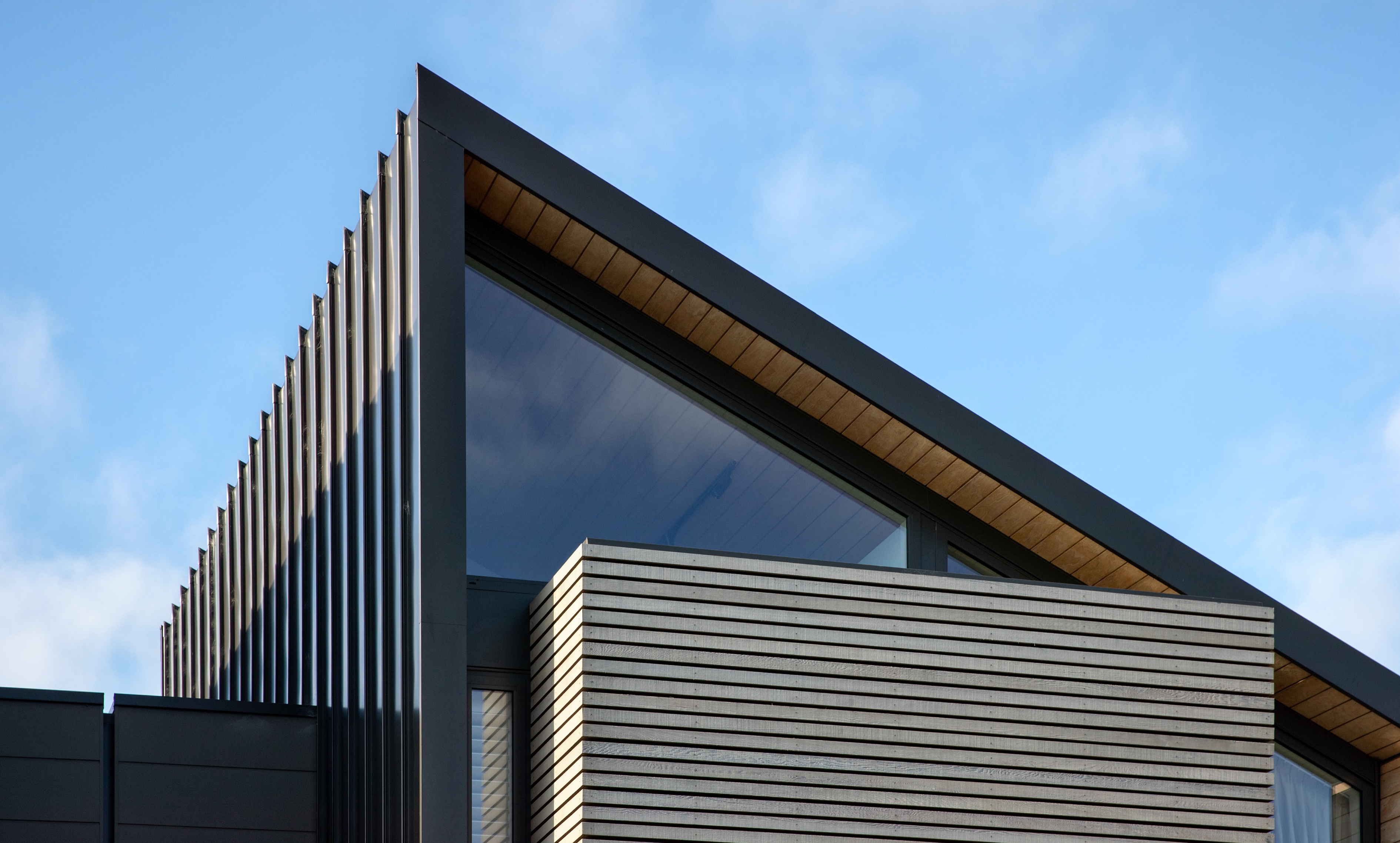 Peterborough Street pitched, dark-steel roof against blue sky