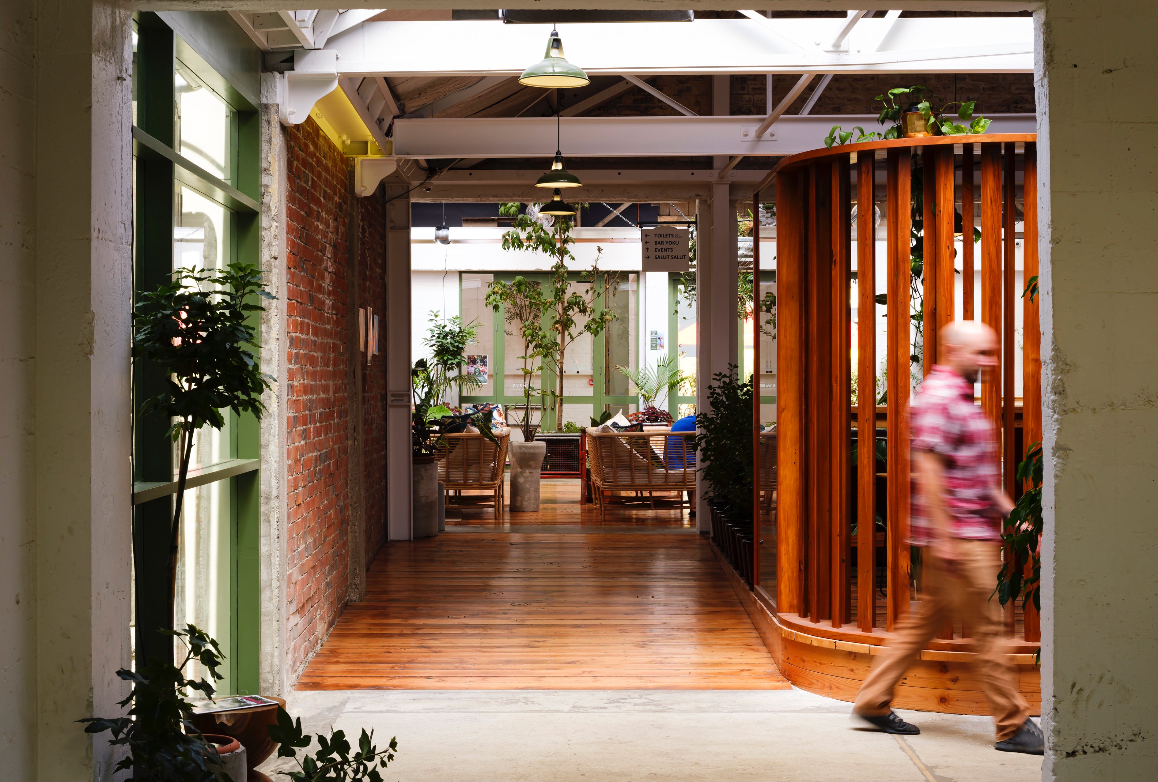 Interior looking through a corridor with original wood and brickwork