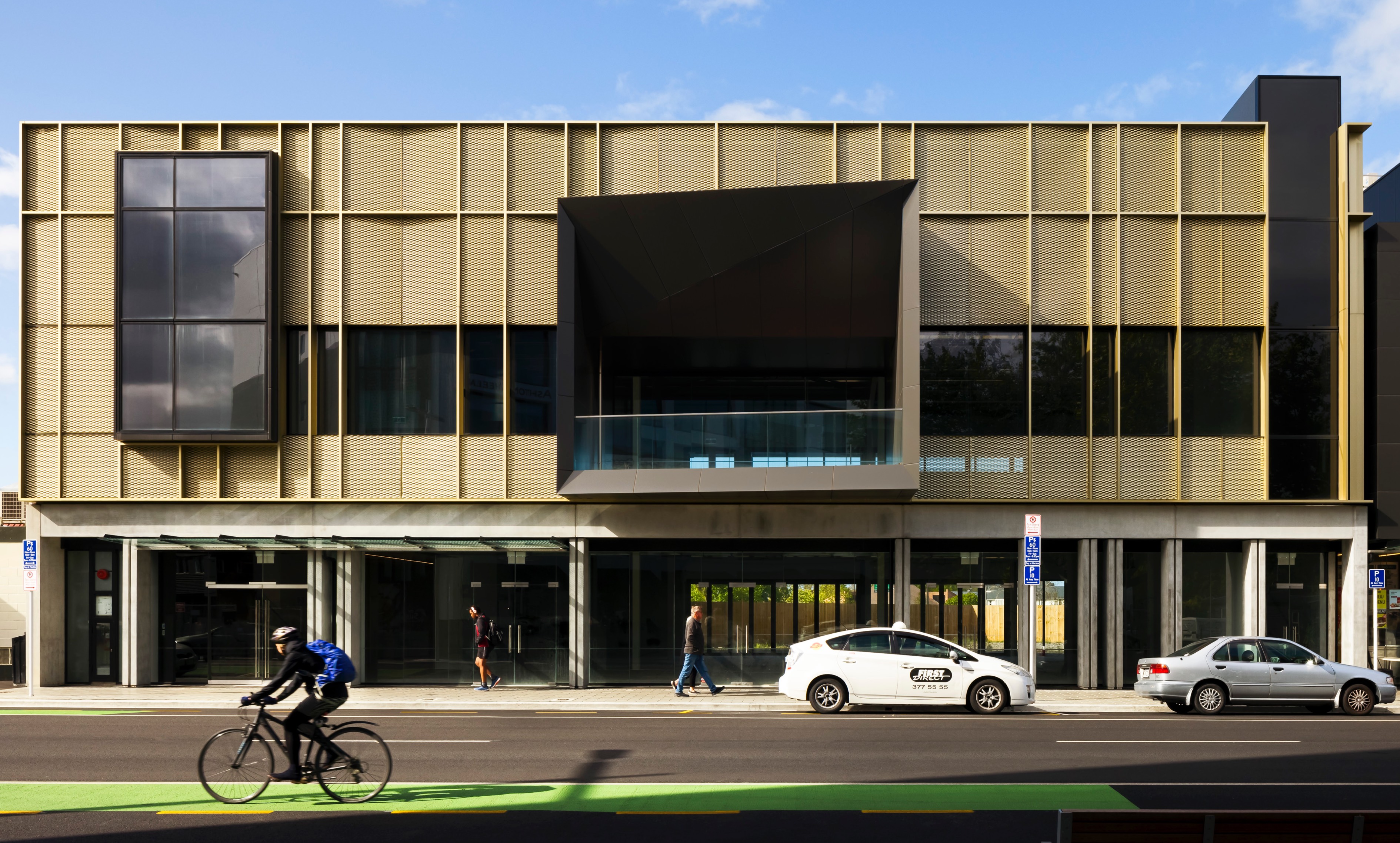 Street view of Victoria Street Development depicting bronze finish and angular features